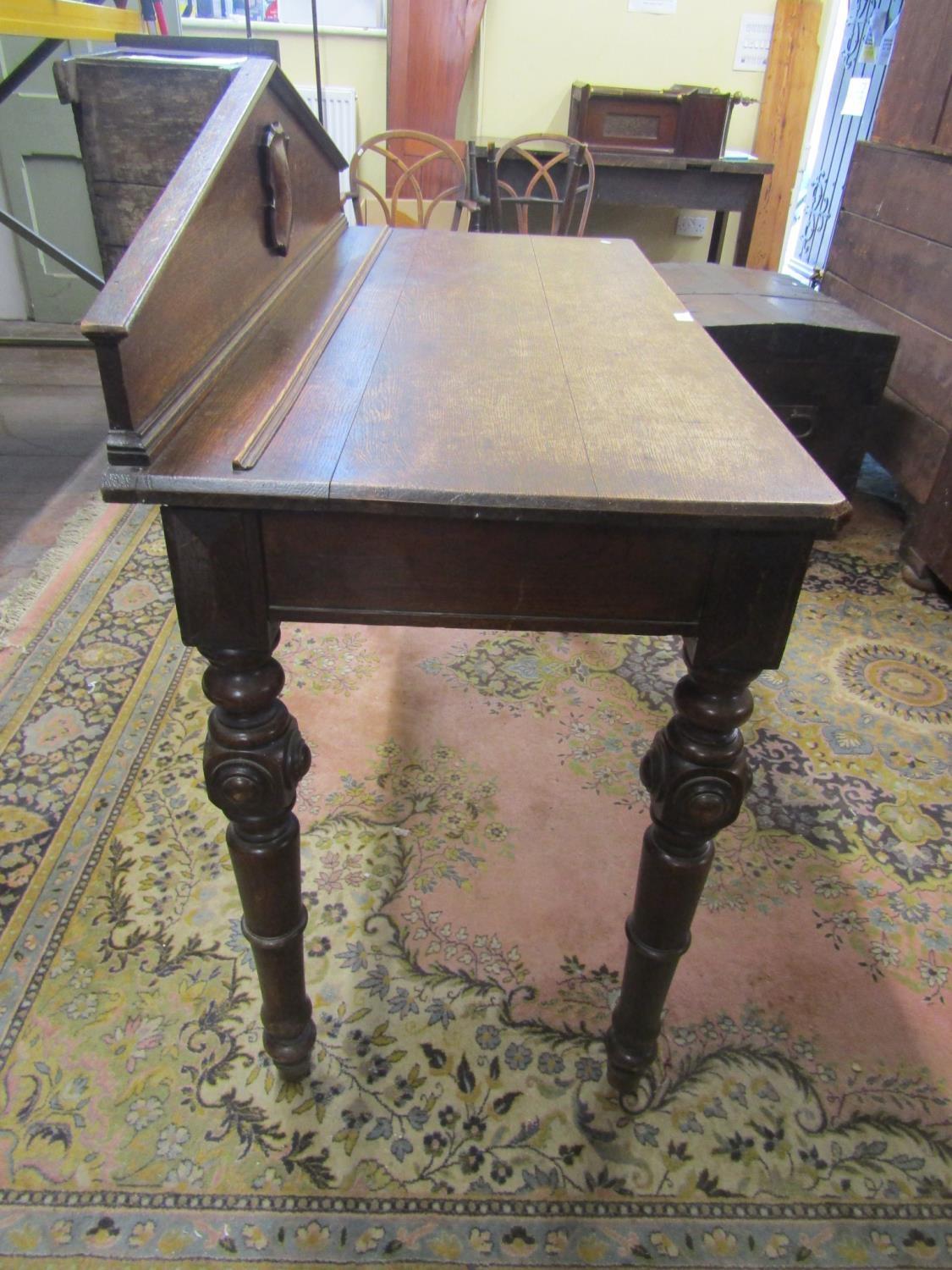 Mid-Victorian oak serving table of rectangular form, enclosing two frieze drawers, raised on four - Image 4 of 4