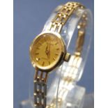 Ladies 9ct Accurist quartz cocktail watch, the oval champagne dial with Roman Twelve and baton