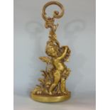 A gilt metal embossed door porter in the Rococo manner decorated with a standing cherub, 50cm high