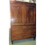 A Georgian mahogany linen press with crossbanding and further inlaid detail moulded cornice over a