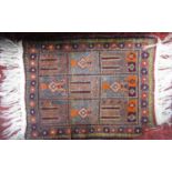 Two Afghan rugs with medallion decoration upon a red ground, the largest 215 x 130cm, together