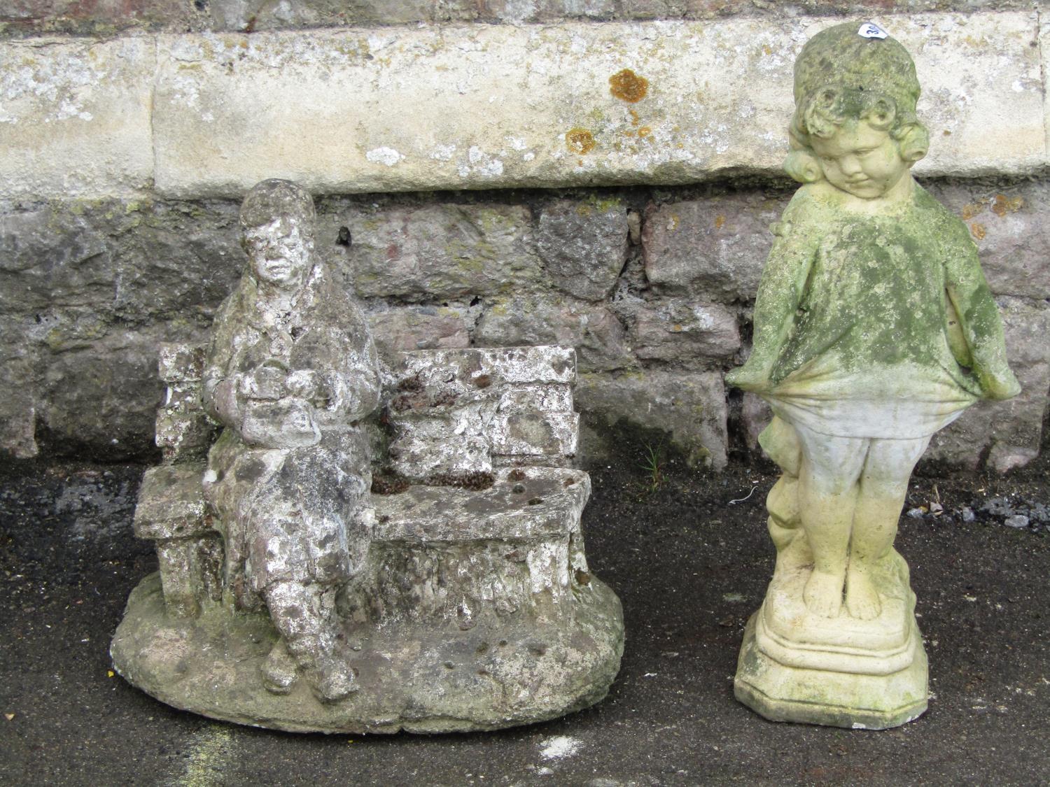 Two weathered reconstituted figures showing a character seated upon a bench and a further example of