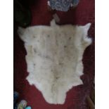 A thick reindeer hide rug, 130 x 80cm