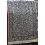 Cashmere type Persian rug with intricate scrolled medallion decoration upon a washed pink ground,