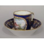 An 18th century Sevres blue ground cabinet cup and saucer with central Watteauesque style painted