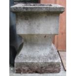 A weathered composition stone garden urn of square cut and swept form 41 cm square x 57 cm in height