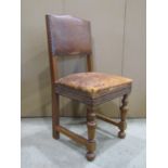 A set of six (4+2) oak framed dining chairs, loosely in the Cromwellian style with worn tan