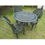 A green painted aluminium garden terrace table of circular form with decorative pierced detail,