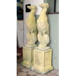 A pair of contemporary cast composition stone garden ornaments in the form of whippets/hounds,