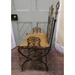 A decorative continental ironwork side chair with X shaped supports and brass rails, back panel