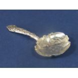 William IV silver caddy spoon, the lobed bowl engraved with scrolled foliage with a cast handle,