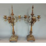 A pair of ecclesiastical French four branch candelabra, with scrolled foliate sconces, tapered