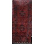 Good quality Persian rug with star, medallion and floral decoration upon a deep red ground, 160 x
