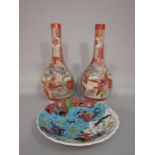 A pair of tall early 20th century Satsuma bottle shaped vases with drawn necks and painted male