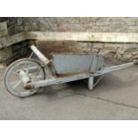 An old traditional wooden wheelbarrow with through jointed and chamfered frame, timber spoke wheel
