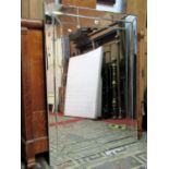 A contemporary wall mirror of rectangular form with bevelled edged marginal surround, 84 cm wide x
