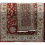 Large full pile Indian carpet with repeating scrolled floral decoration, together with a smaller
