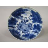 A 19th century tin glazed earthenware charger with blue and white painted decoration of Ceres