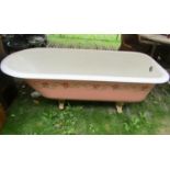 A Victorian cast iron and enamel roll top bath with gilt painted claw and ball feet