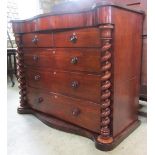 A Victorian mahogany bedroom chest with serpentine frieze enclosing a central over a flat fronted