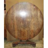 A 19th century rosewood veneered loo table of circular form, raised on an inverted octagonal