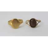 18ct signet ring (cut), 5.7g and a goldstone ring, worn marks to outer shank, size P, 1.8g (2)