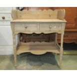 A 19th century stripped pine wash stand with raised three quarter shaped gallery, over two frieze