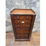 A small 19th century mahogany Wellington chest of seven graduated drawers with central locking