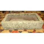 A weathered natural stone trough of rectangular form, 72 cm long x 38 cm wide x 18 cm deep