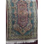 Full pile rug with washed pink and green decoration upon a cream ground, 150 x 90cm