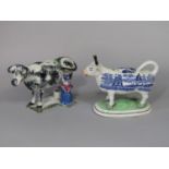 Two 19th century Staffordshire type pottery cow creamers, one with black sponged patches and with