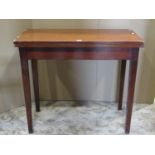 19th century mahogany fold-over top tea table of rectangular form raised on square tapered supports,