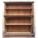 An open oak bookcase with partial carved detail, enclosing adjustable shelves, 150cm high x 130cm