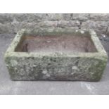 A weathered natural stone trough of rectangular form 68 cm long x 47 cm wide x 23 cm deep