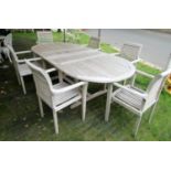 A contemporary weathered (silvered) teak D end pull out extending garden table with slatted top,
