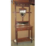 A late Victorian/Edwardian walnut hall stand of full height, the raised moulded open framework