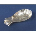 A good quality early 20th century silver caddy spoon, the scalloped bowl embossed with a tea picker,