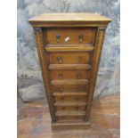 An Edwardian oak Wellington chest comprising seven drawers, with applied repeating moulded detail