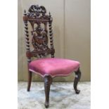 A Victorian walnut nursing chair, the elaborate carved back, with scrolling acanthus, dragon, urn