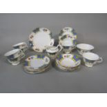 A six place Grosvenor China Windsor pattern tea service including milk jug, sugar bowl, cake