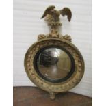 A regency convex mirror, in carved pine (showing traces of original gilt work) the circular mirror