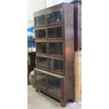 An Art Deco style oak freestanding five sectional oak library bookcase, each section enclosed by a