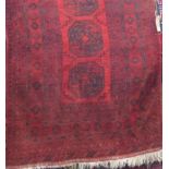 Bokhara type rug with geometric medallion decoration upon a deep red ground, 190 x 130cm