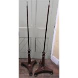 A pair of 19th century mahogany pole screen frames on tripod bases, with tapering pillars