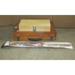 A portable wooden and board portable tool chest containing various long handled woodworking chisels,