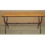 A light oak bench with plank seat and iron work X framed supports, united by a central rail, 94cm