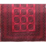 A good quality Bokhara carpet with typical geometric medallion decoration upon a deep red ground,