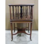 A small Edwardian mahogany floorstanding revolving bookcase of square form, with turned spindle