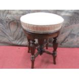 A good Victorian walnut piano stool possibly by Gillows with circular rising seat, raised on