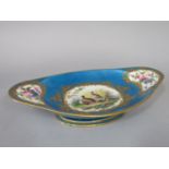 An 18th century Sevres dish of elongated oval form with painted central panel of Partridges in a